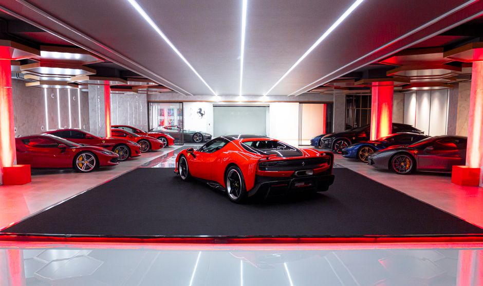 Collection of sleek luxury sports cars in a stylishly lit indoor showroom.